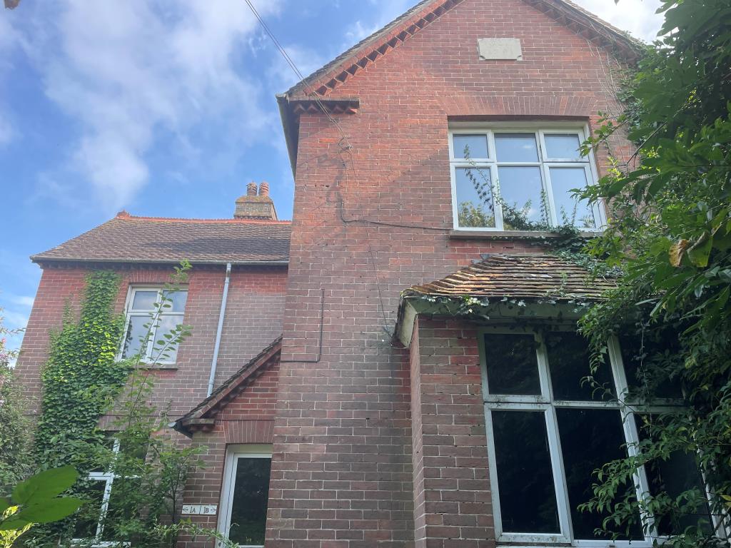Lot: 99 - HOUSE ARRANGED AS TWO FLATS WITH LARGE GARDENS - Main photo of front of property from pathway